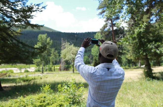 A GLOBE community member using The GLOBE Program's App, GLOBE Observer, to collect cloud data