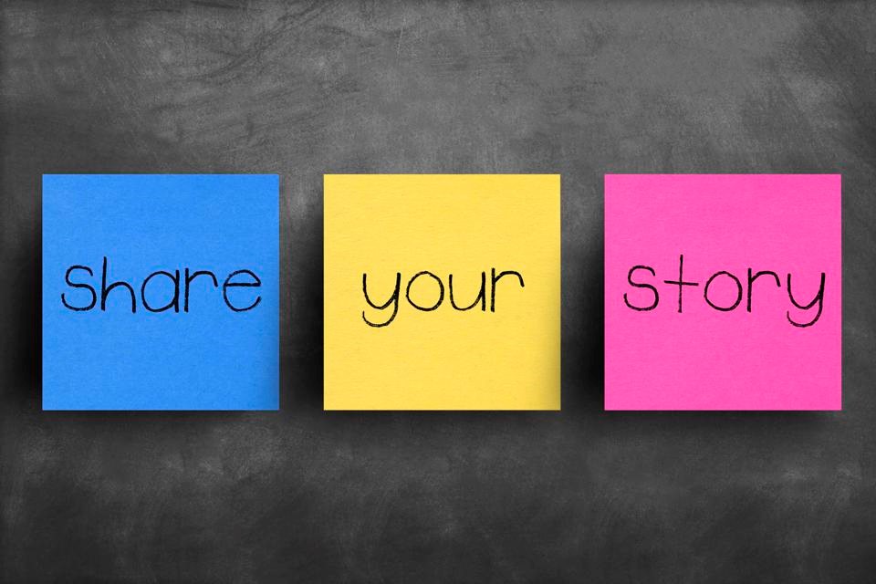 A photo of three sticky notes on a blackboard, reading "Share" and "Your" and "Story"