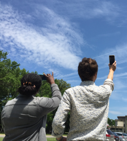 NASA photo of community members taking cloud observations