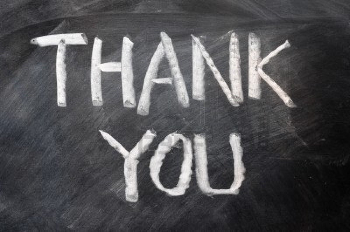 Sign written in chalk on a chalkboard that reads "Thank You"