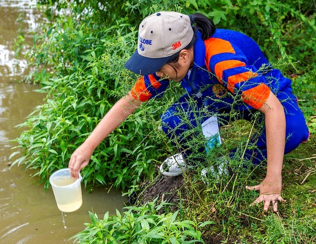 A photo of a GLOBE student in action, collecting data