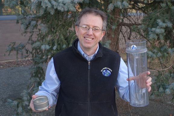 Dr. Murphy with his soil can and rain gauge.