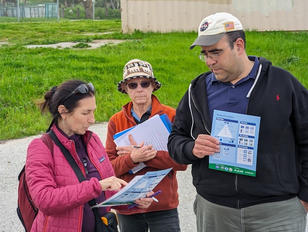 three Pacific North American Regional Meeting attendees look at the GLOBE clouds chart