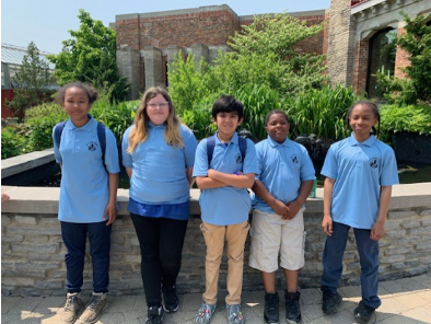 five students at the Toledo Zoo for the GLOBE in the Prairie student research symposium