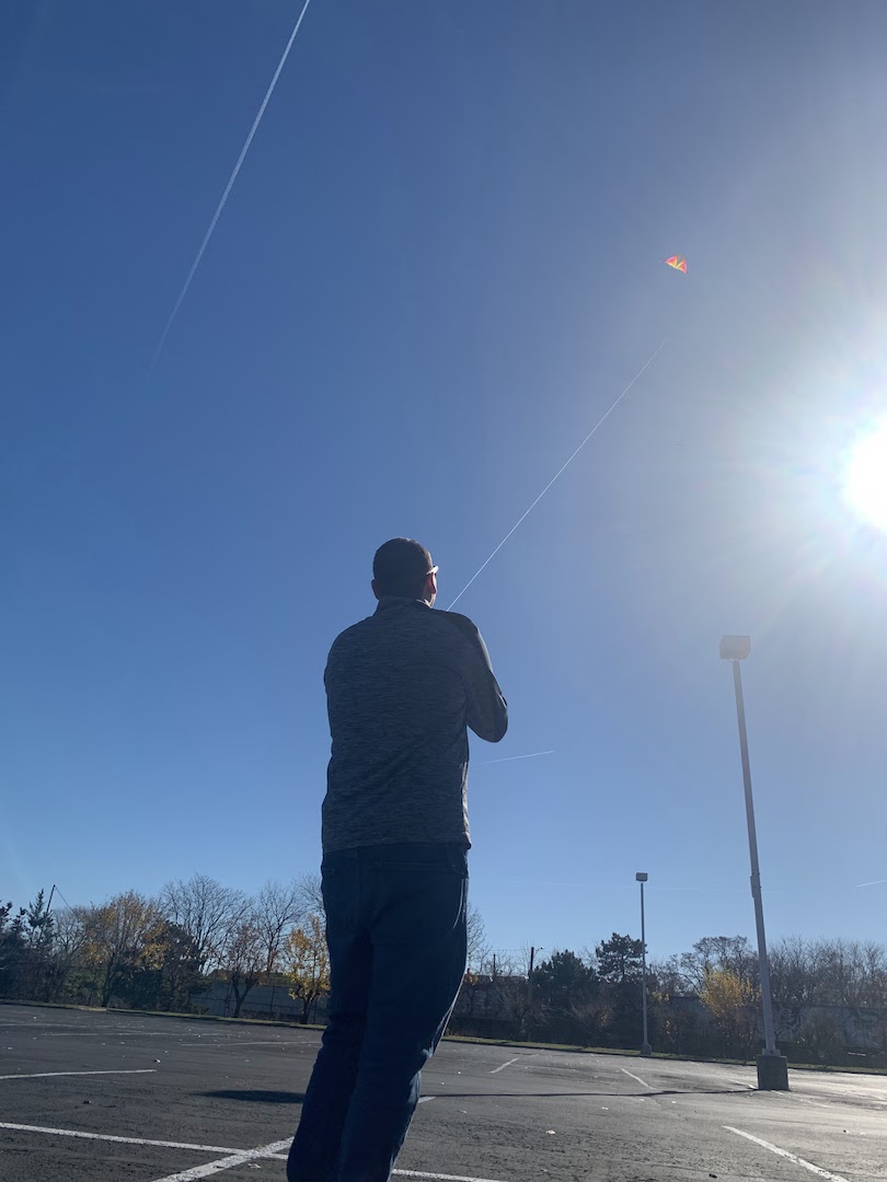 a participant flies an AEROKAT device on a special kite to collect weather data