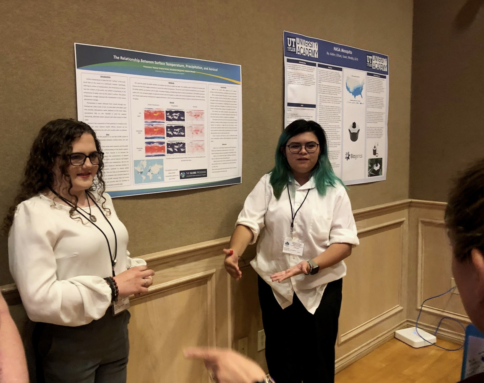 Two students present their poster at the SRS