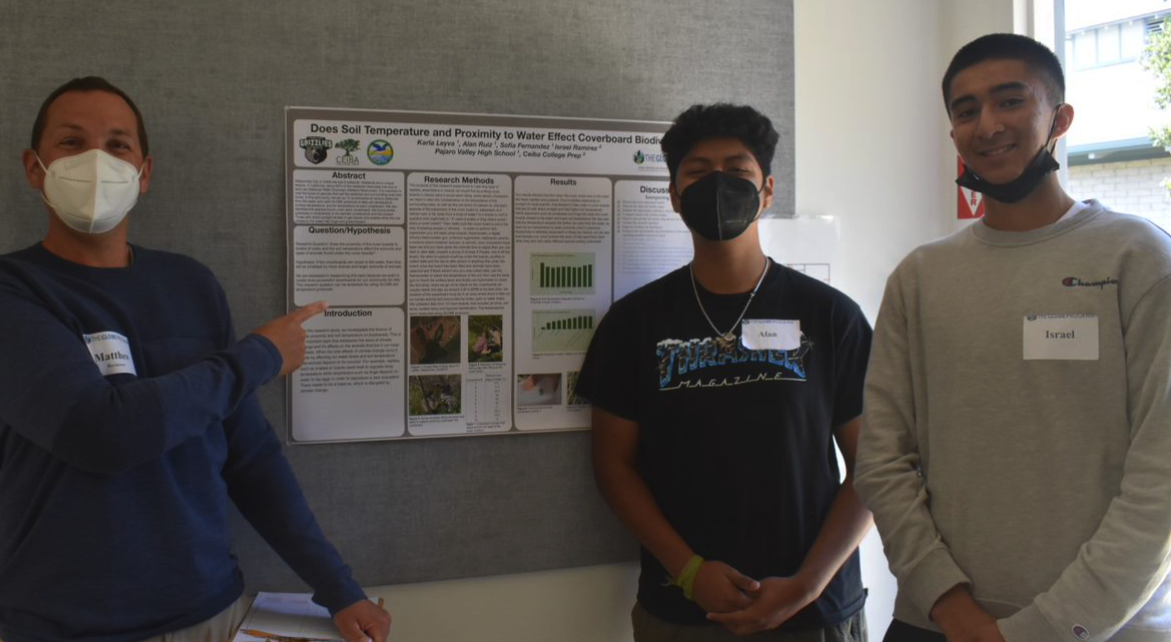 Three high school students presenting a poster at the 2022 SRS