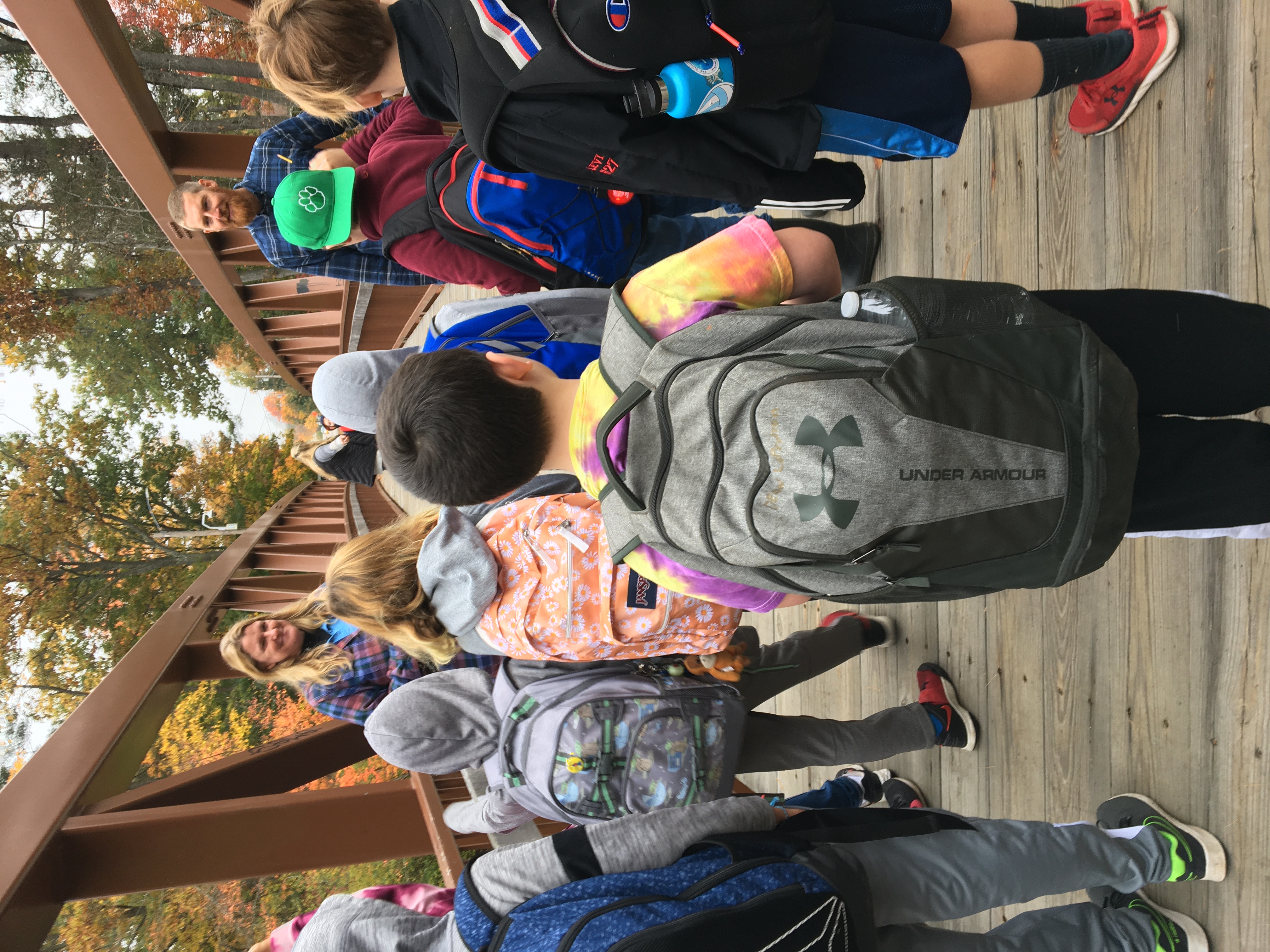 scientists and students stand on a bridge over the Cocheco River