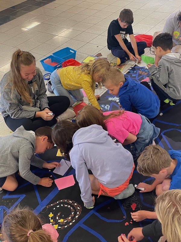 students work on the soil mural at the Soil and Solar Festival