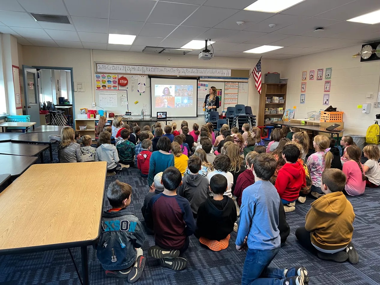 students at Hampstead Central School (New Hampshire, USA) watch students from Timoleague National School (Ireland) on a screen in their classroom during a virtual meeting between the two schools