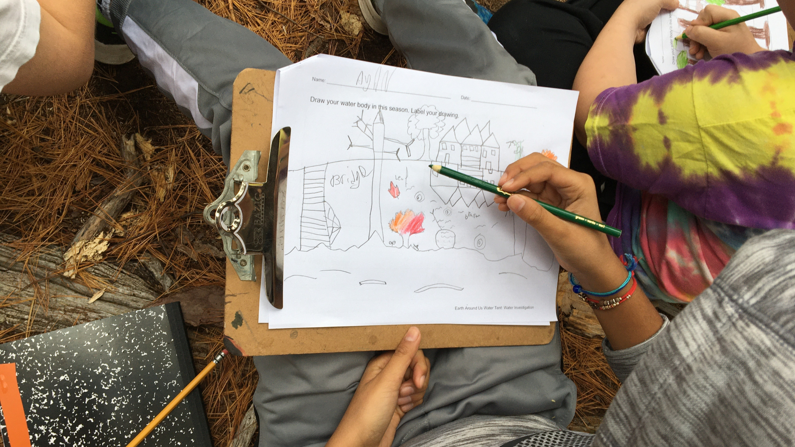 a student sketches the landscape along the Cocheco River during the fall season
