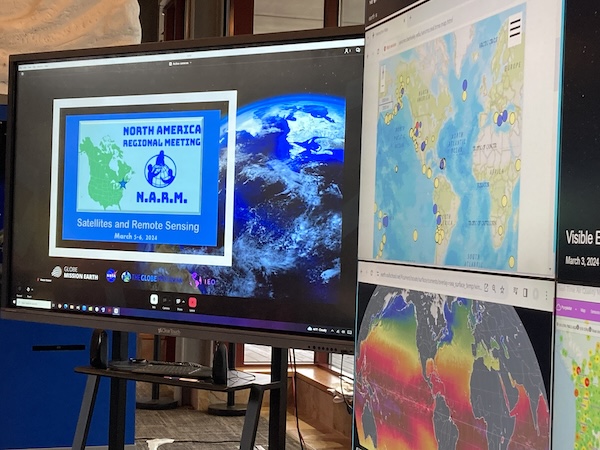 at the North American Regional Meeting in Palmyra, New Jersey, on March 5 and 6, 2024, satellite images, maps and data are projected on multiple screens