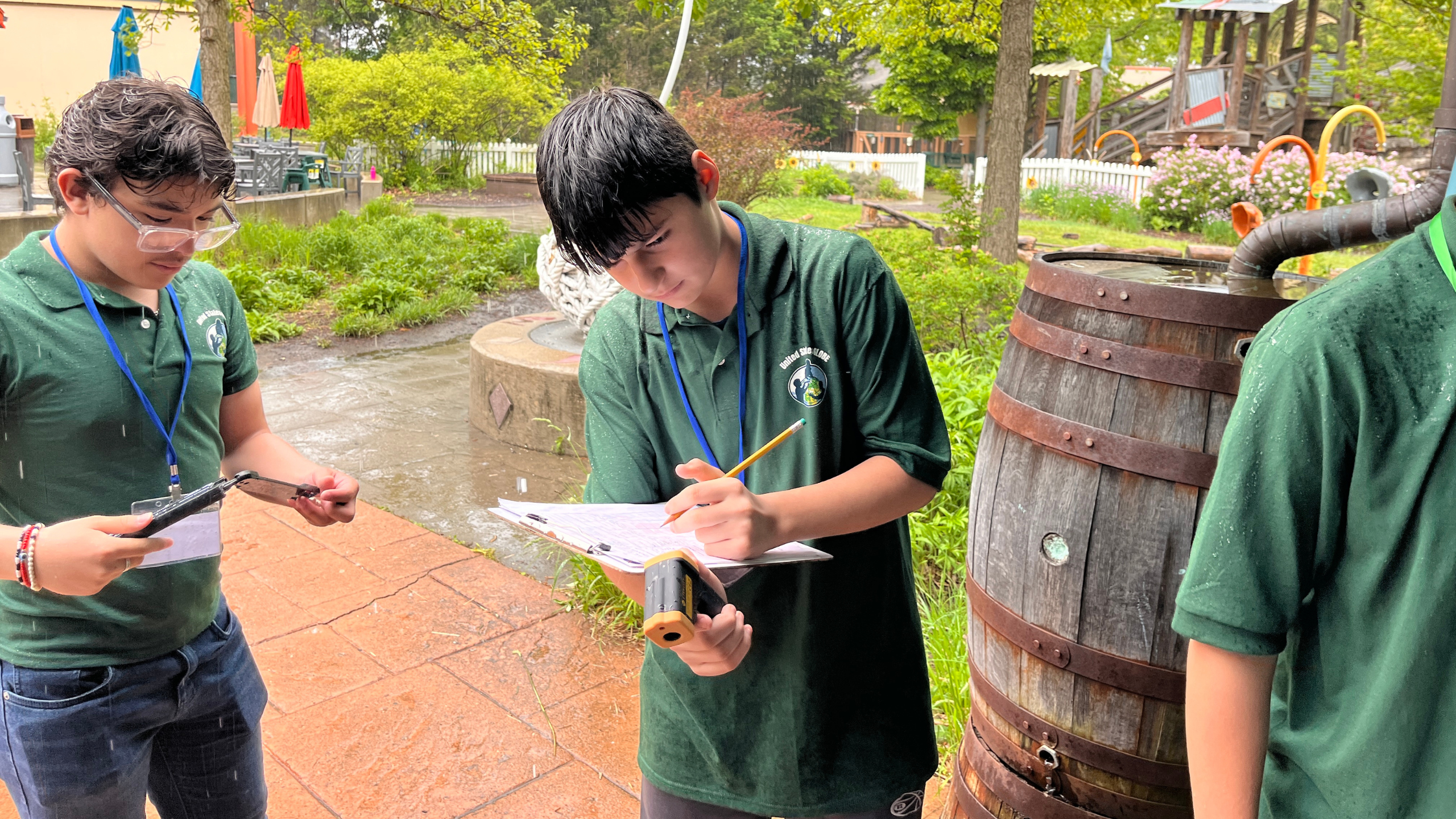 students collect surface temperature data with an infrared thermometer on the grounds of the Toledo Zoo and Aquarium