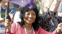 Elena Sparrow at the GLE 2018 parade holding the flag of Alaska.