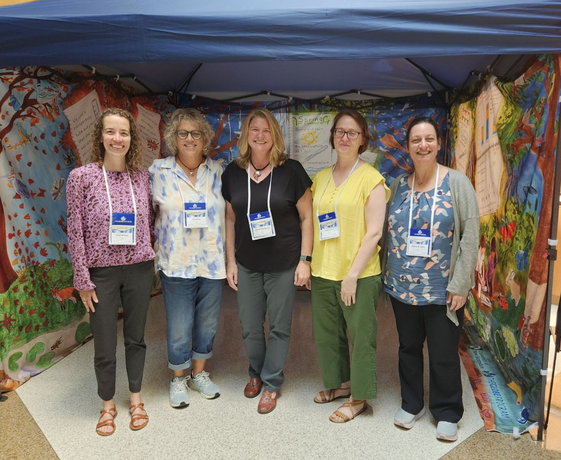 NH and US GLOBE Team stands in the soil tent at the GLOBE Annual Meeting