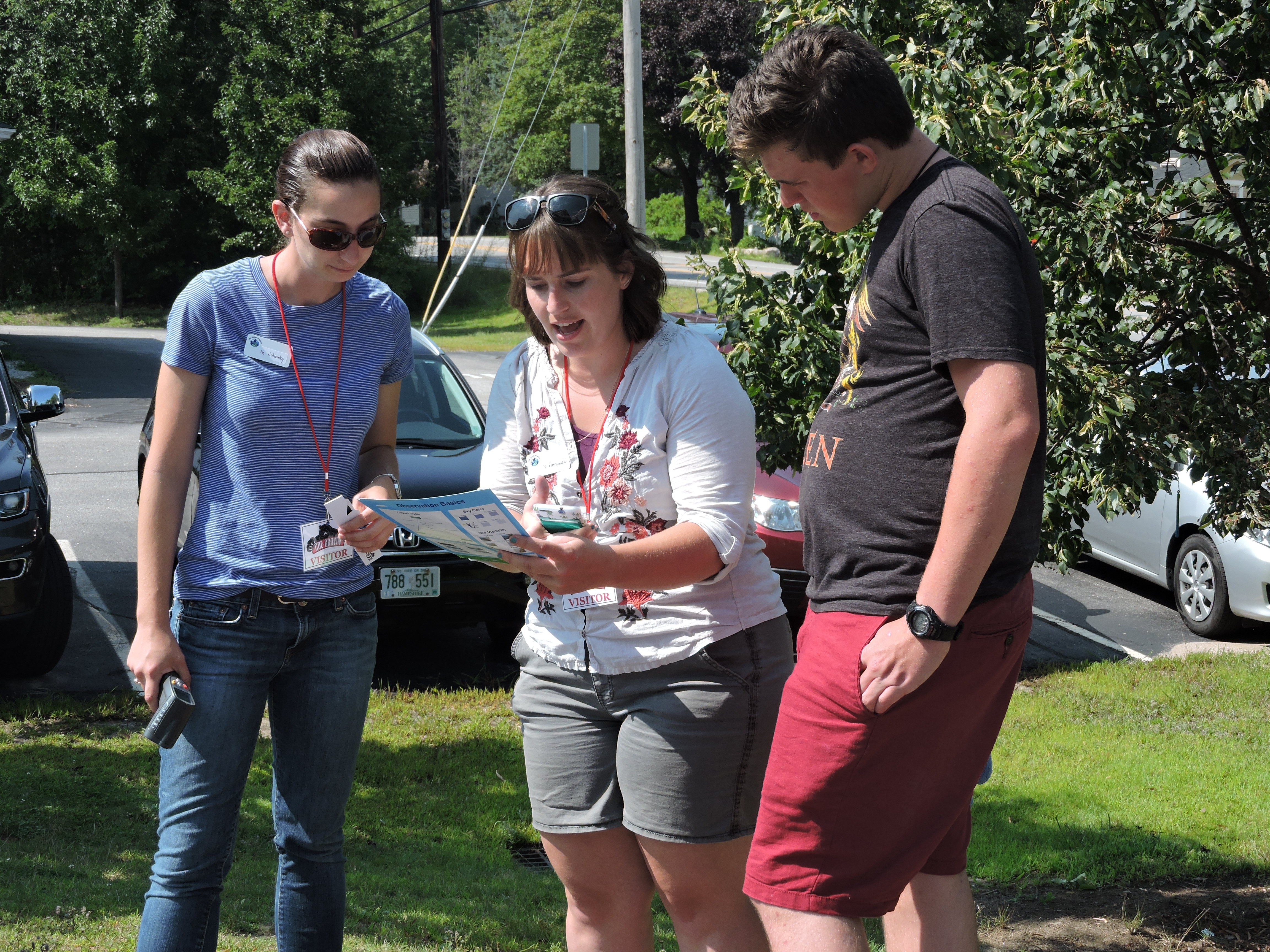 two female graduate students and one young male student looking a thte cloud chart