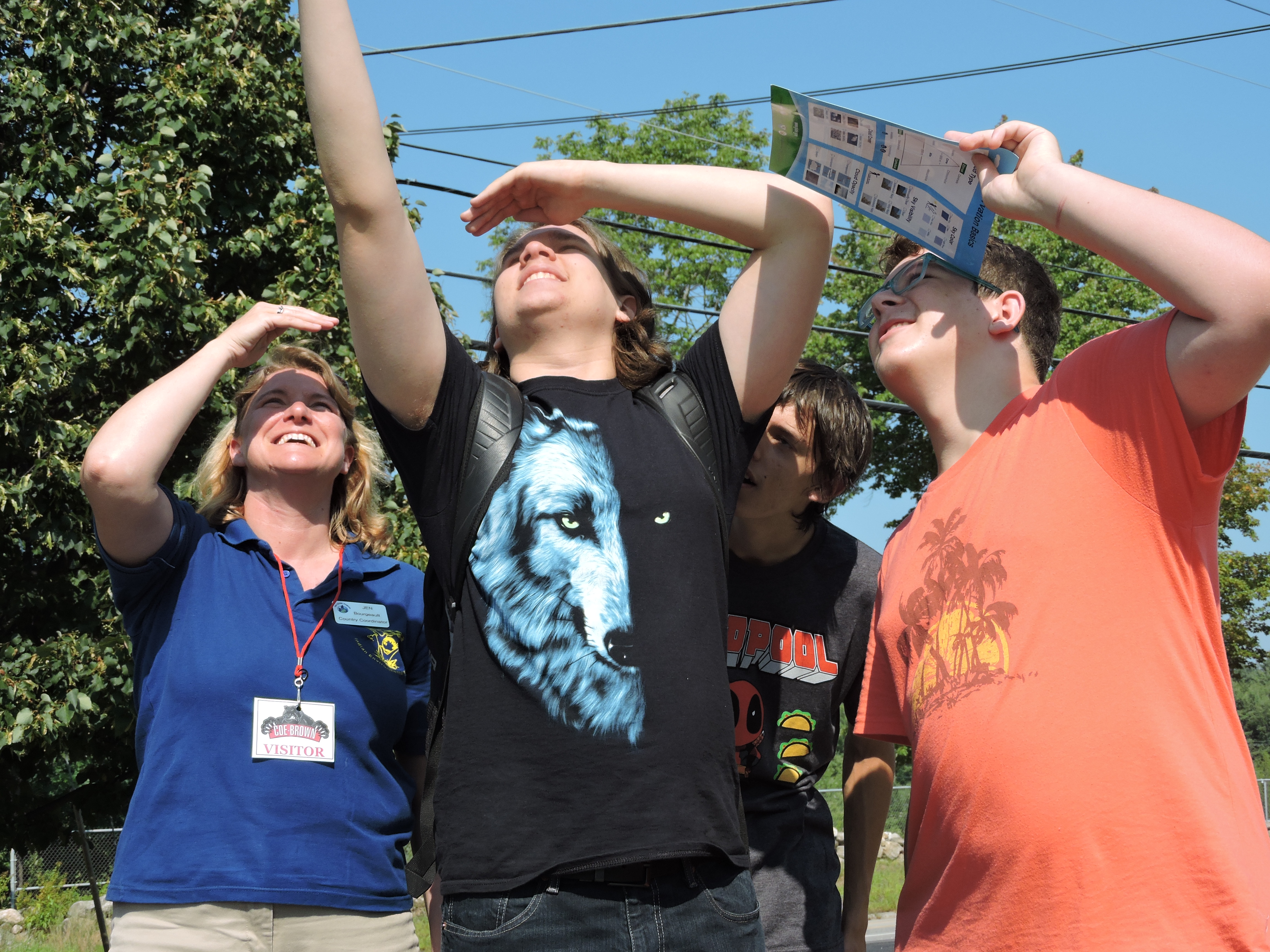 bourgeault and two young male students looking up at the sky to identify clouds