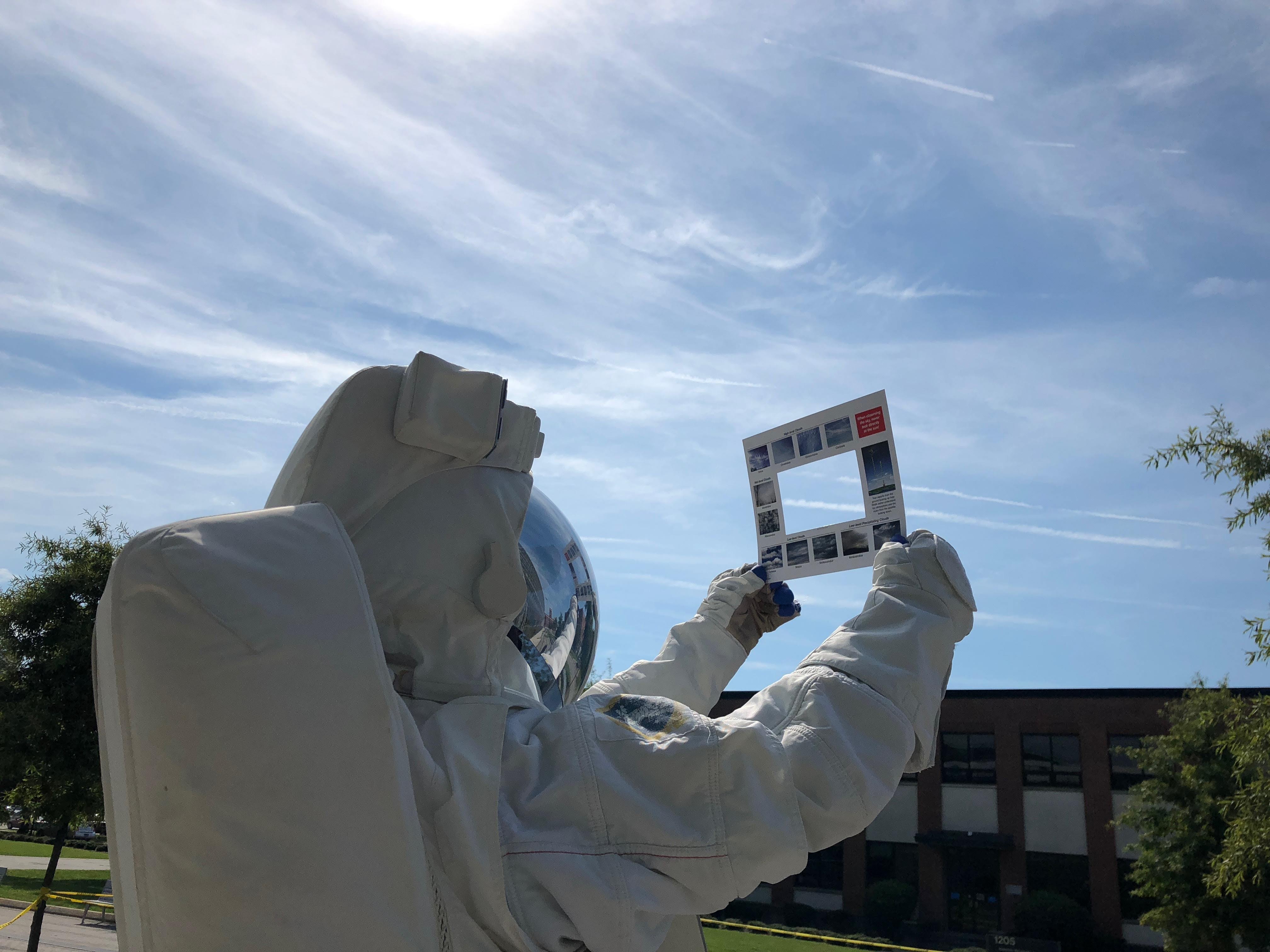 Image of someone in a space suit using a GLOBE Clouds Window