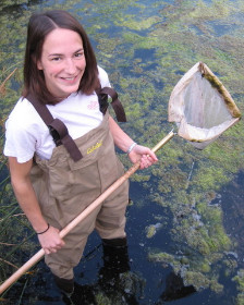 Image of Sara Paull standing in water with waders and with a net