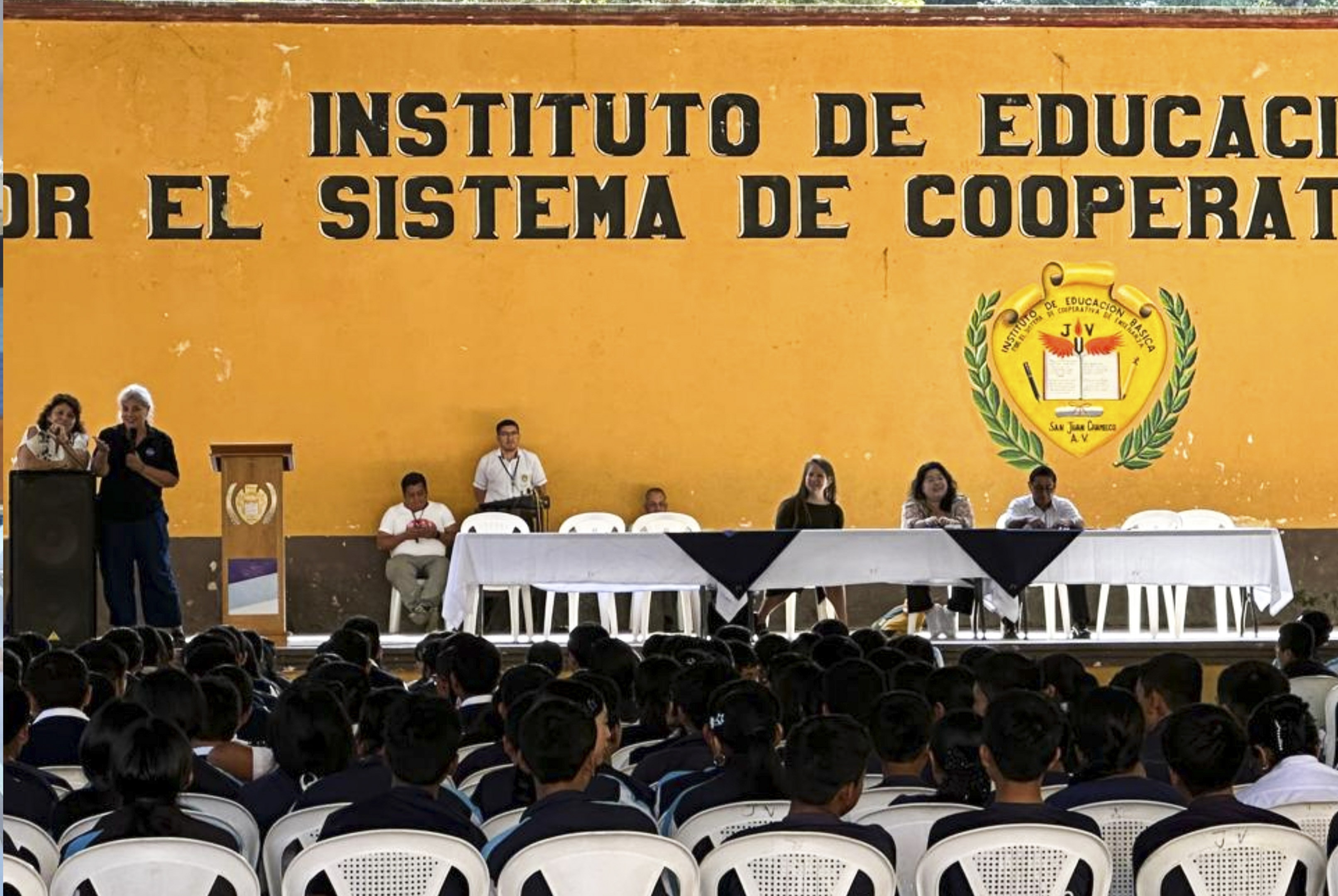 People speaking on stage.