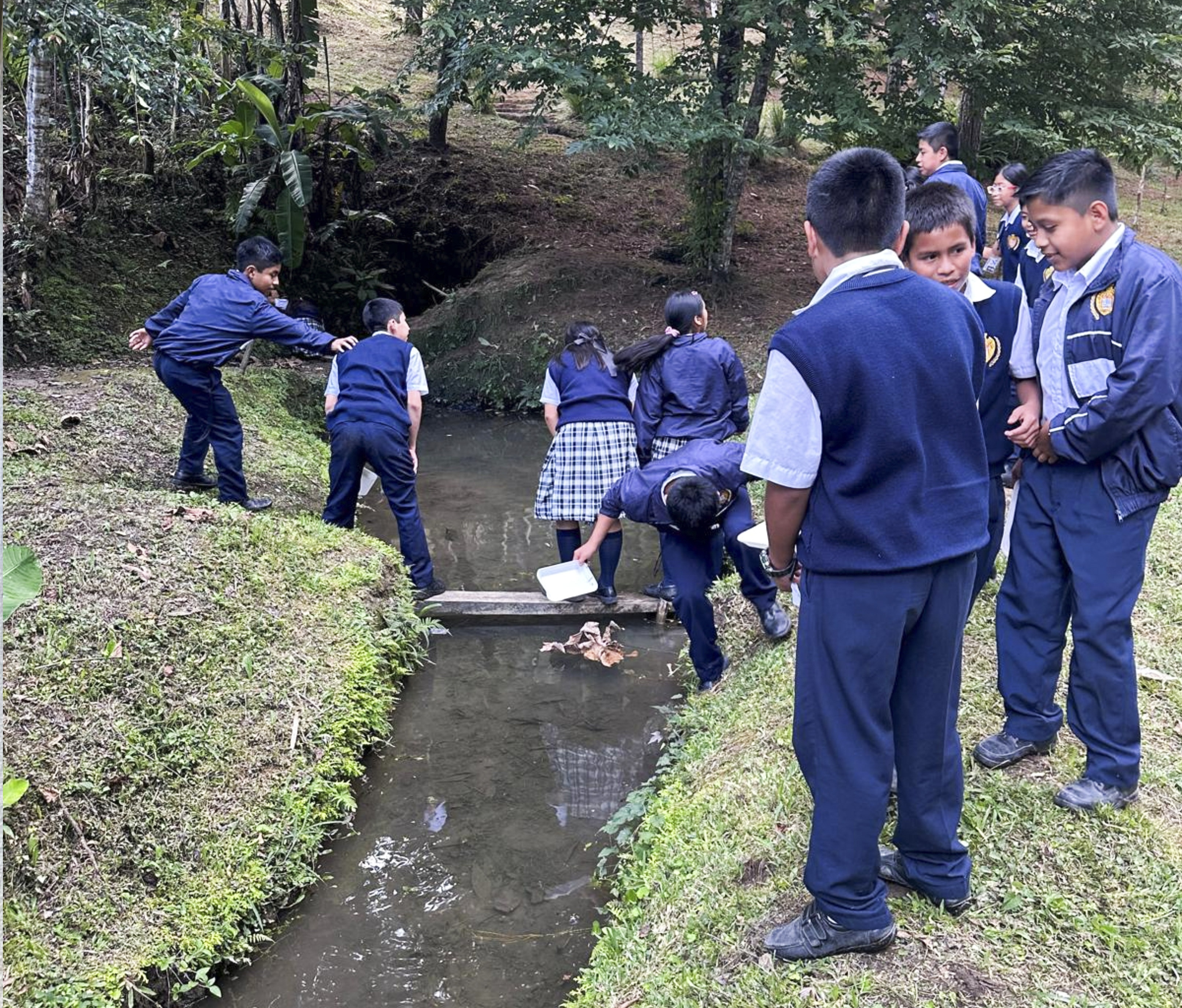 Student collecting water samples.