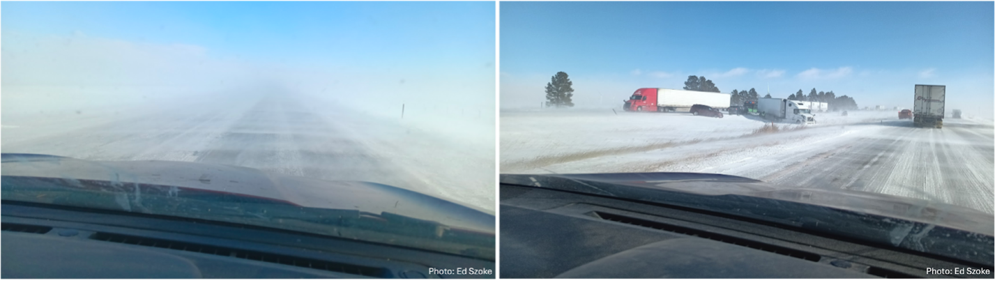 Highway obscured by blowing snow as seen from inside a vehicle.
