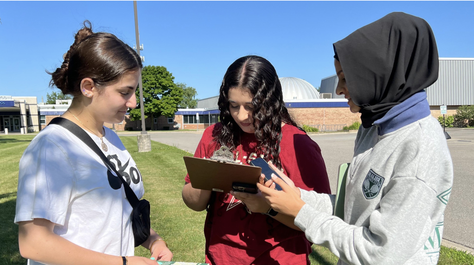 Three students collecting GLOBE data in the field