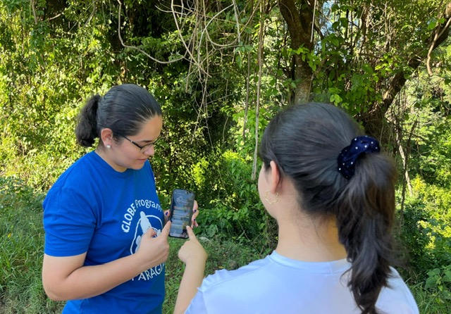 Elida Moreno working with a female student outside