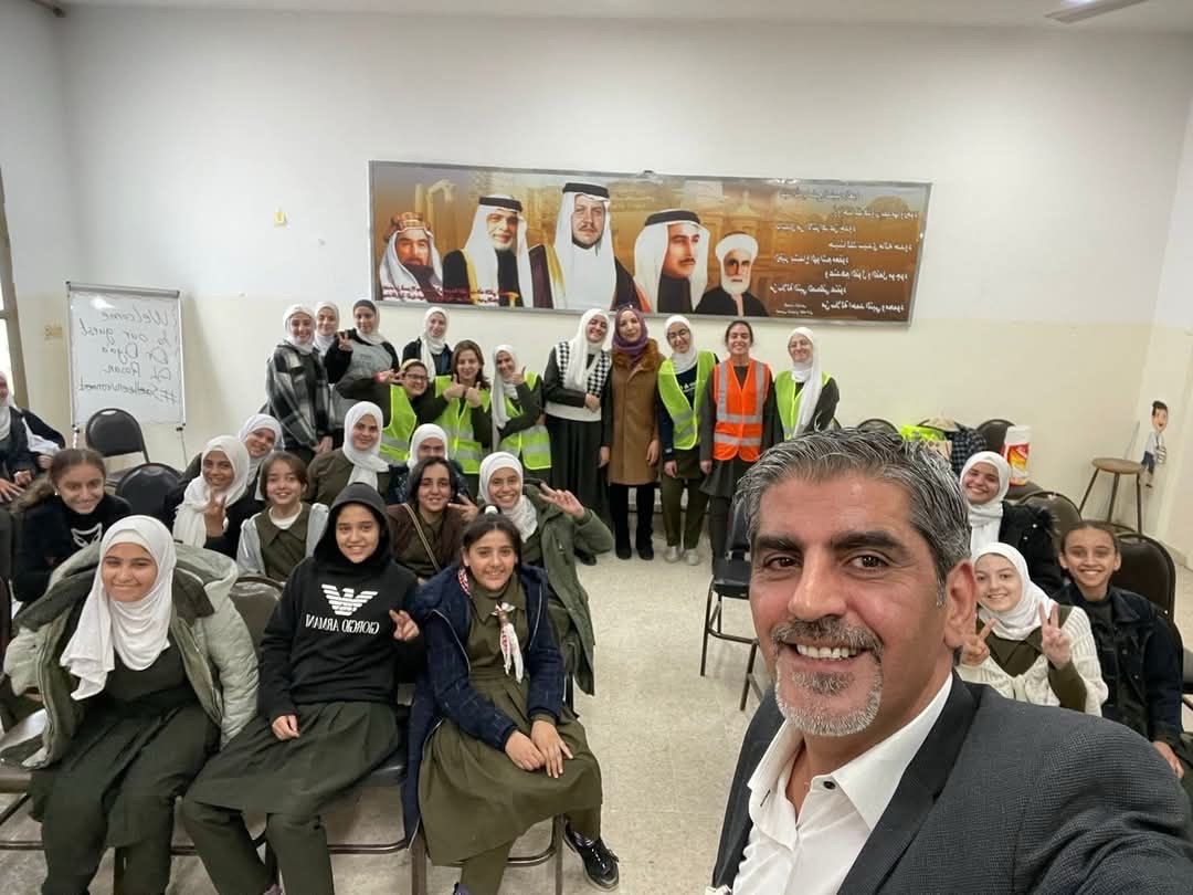 Group if students sitting in chairs with an adult taking a selfie