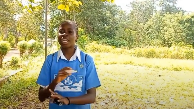   A GLOBE Student Vlogger recording a video in a forest