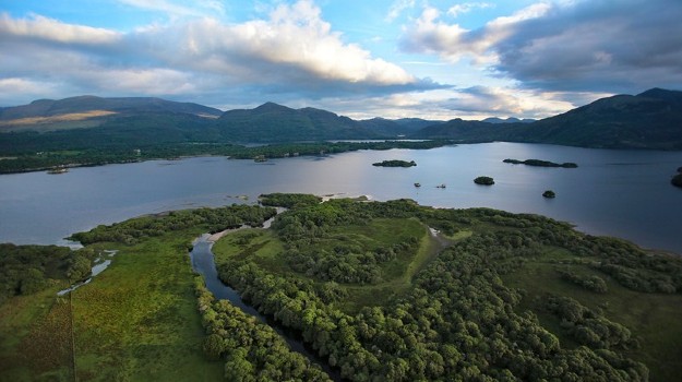   Aerial view of Killarney Lake in Ireland with surrounding mountains and sky