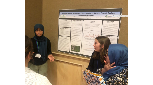   Students showing their research posters to judges