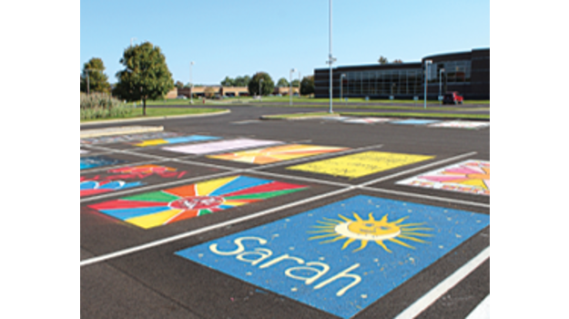   School parking lot with some spaces painted over.