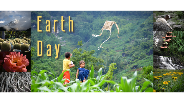   Children celebrating Earth Day by flying a kite on top of a green mountain