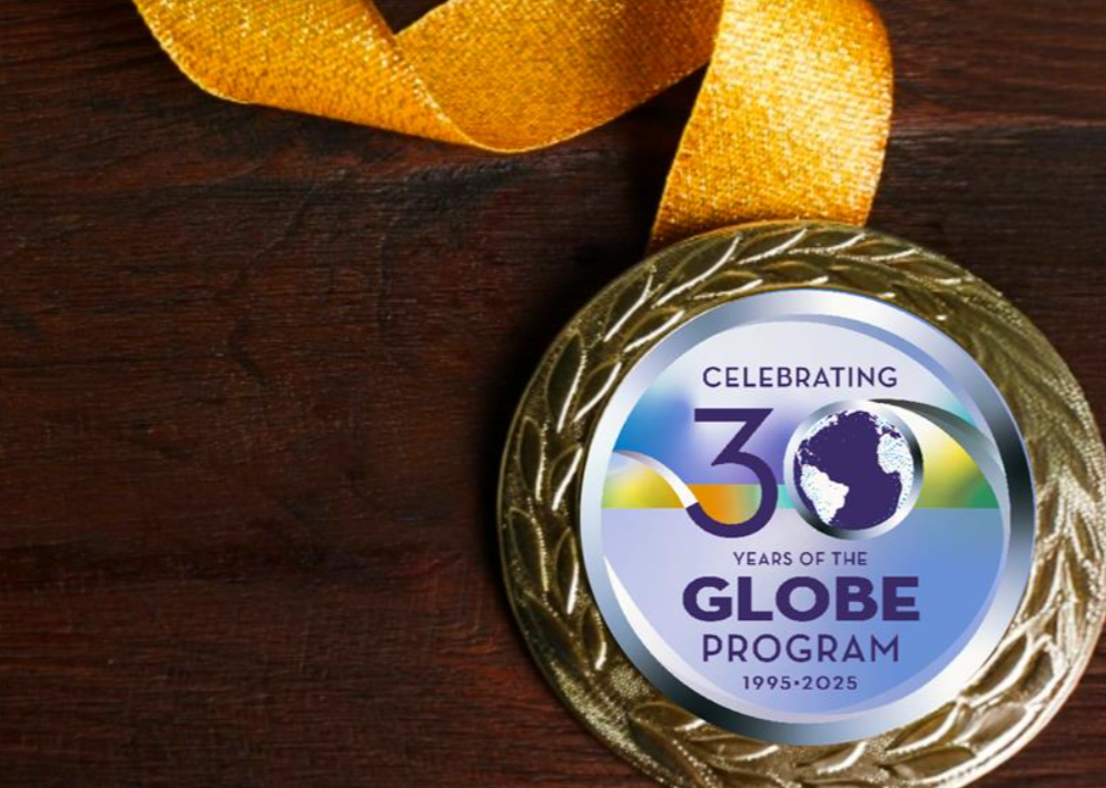 A celebratory gold medal with the GLOBE Annual Meeting round logo on the front