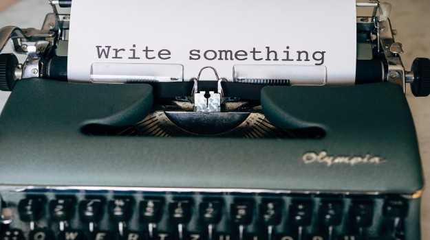   Typewriter that has written out "write something" on paper