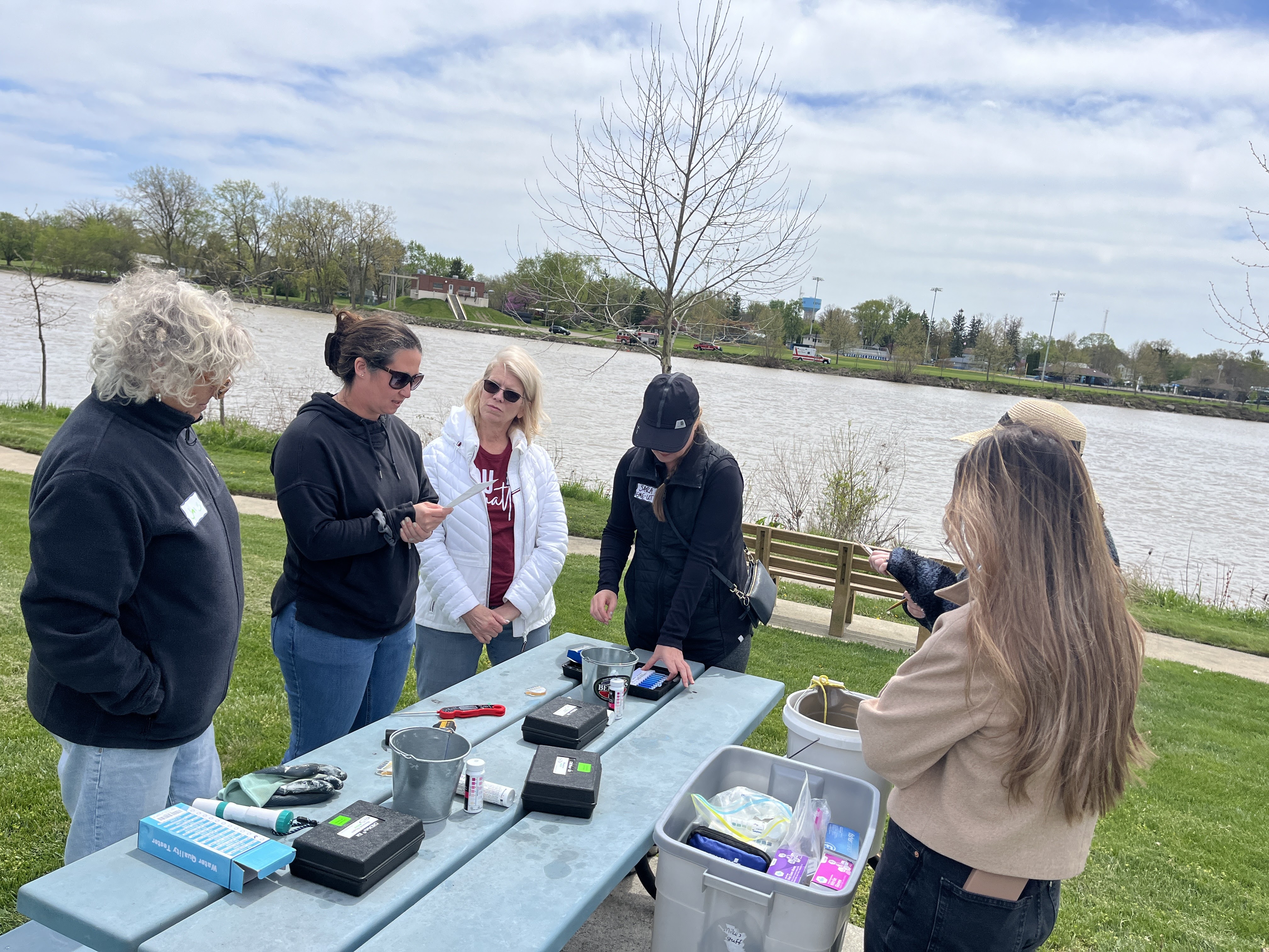 NARM participants prepare to study the Maumee River with various water quality testing kits
