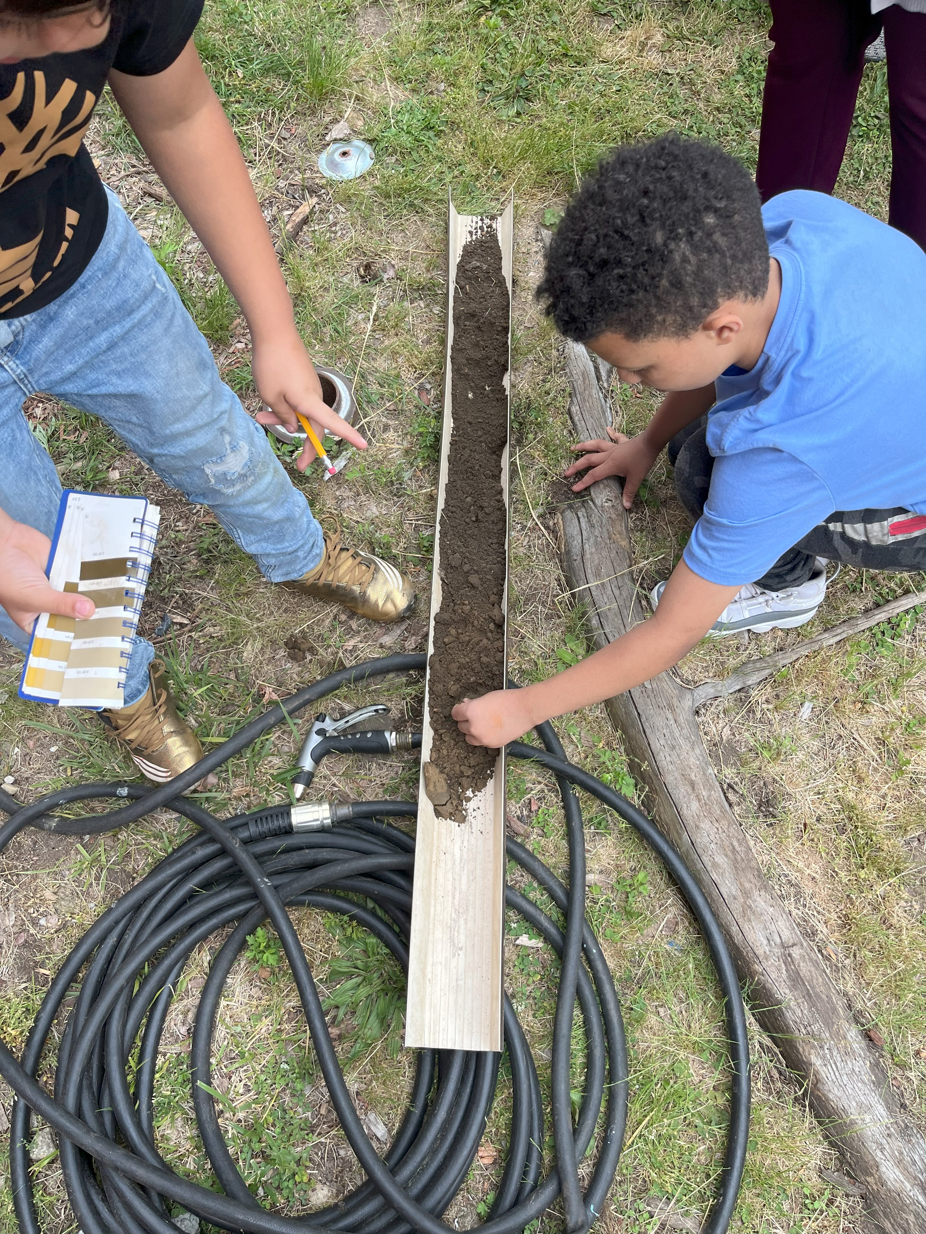 a student examines the texture of a soil sample