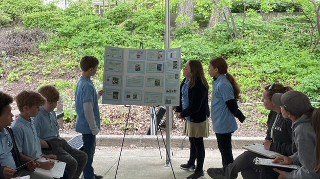 Three students present GLOBE research poster to peers and scientists