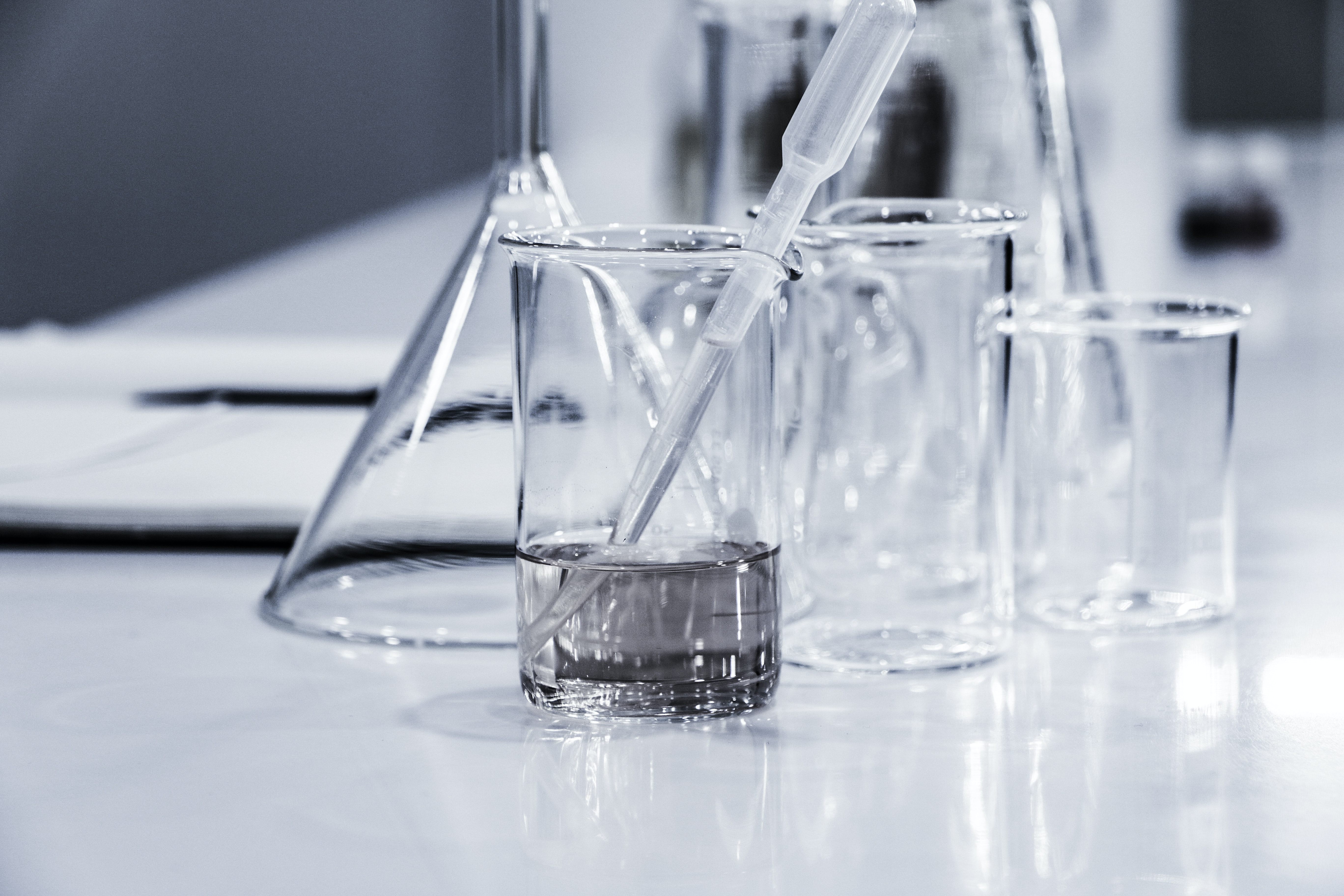   glass beakers with a pipette from unsplash.com