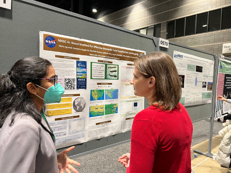 Photo of a student explaining her SEES Earth System Explorer summer research poster to NASA official.