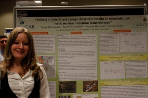 Emily standing with her poster at the UCAR Symposium
