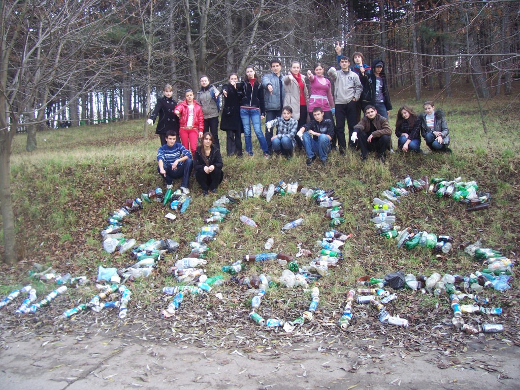 Students from Moldova, Estonia show how much trash they picked up from the side of the road.