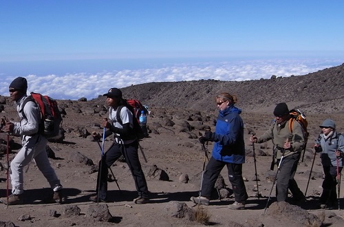 A group of people hike on a mountain.