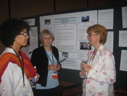 3 women in front of a research poster