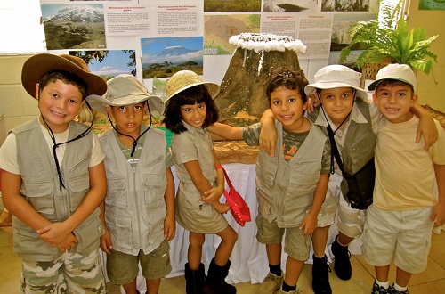  Kids in safari gear stand in front of a classroom presentation.