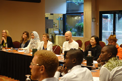 A panel of GLOBE participants listen to a presentation.