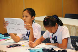 girls looking at paper