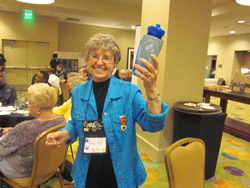 Women smiling holding a water bottle.