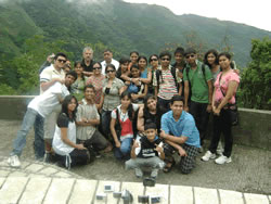 Group posing in front of mountain